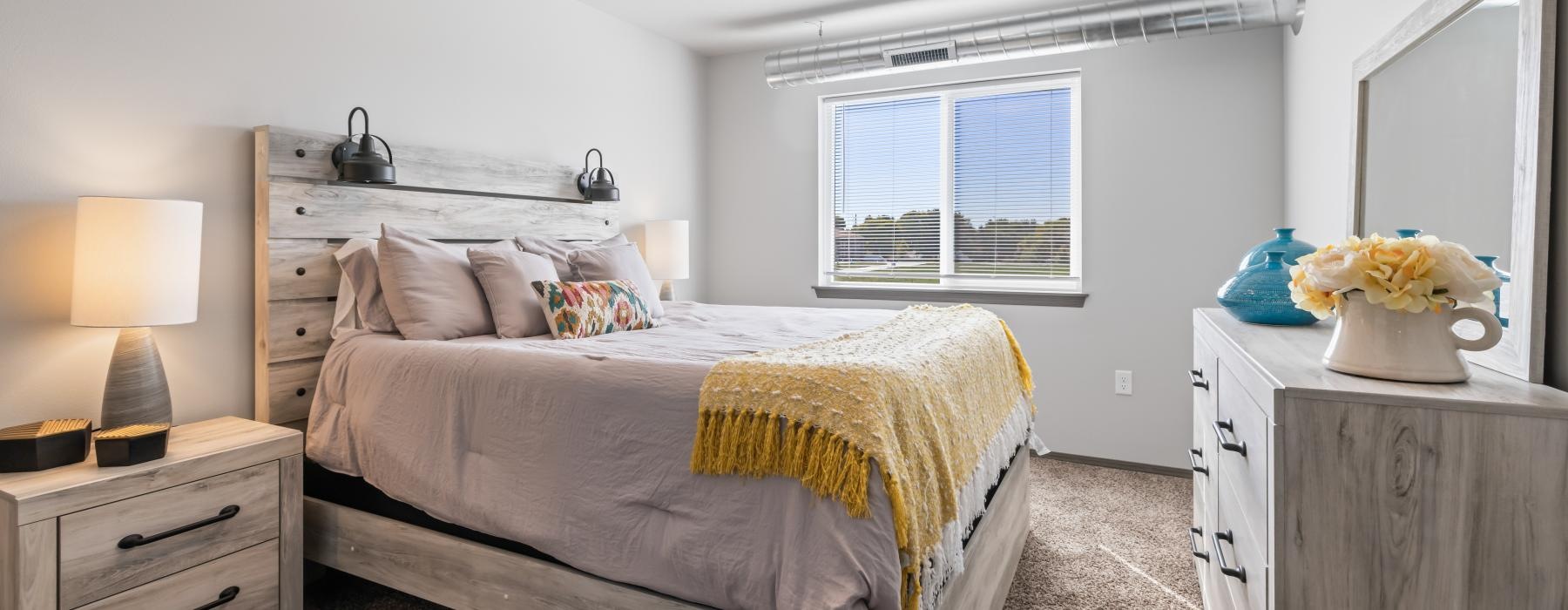 a bedroom with a bed and a dresser