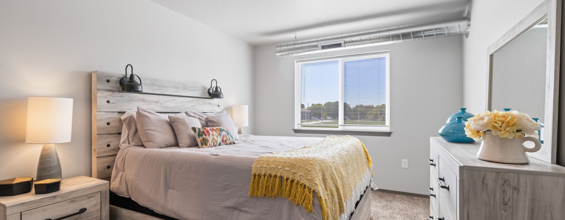 a bedroom with a bed and a dresser